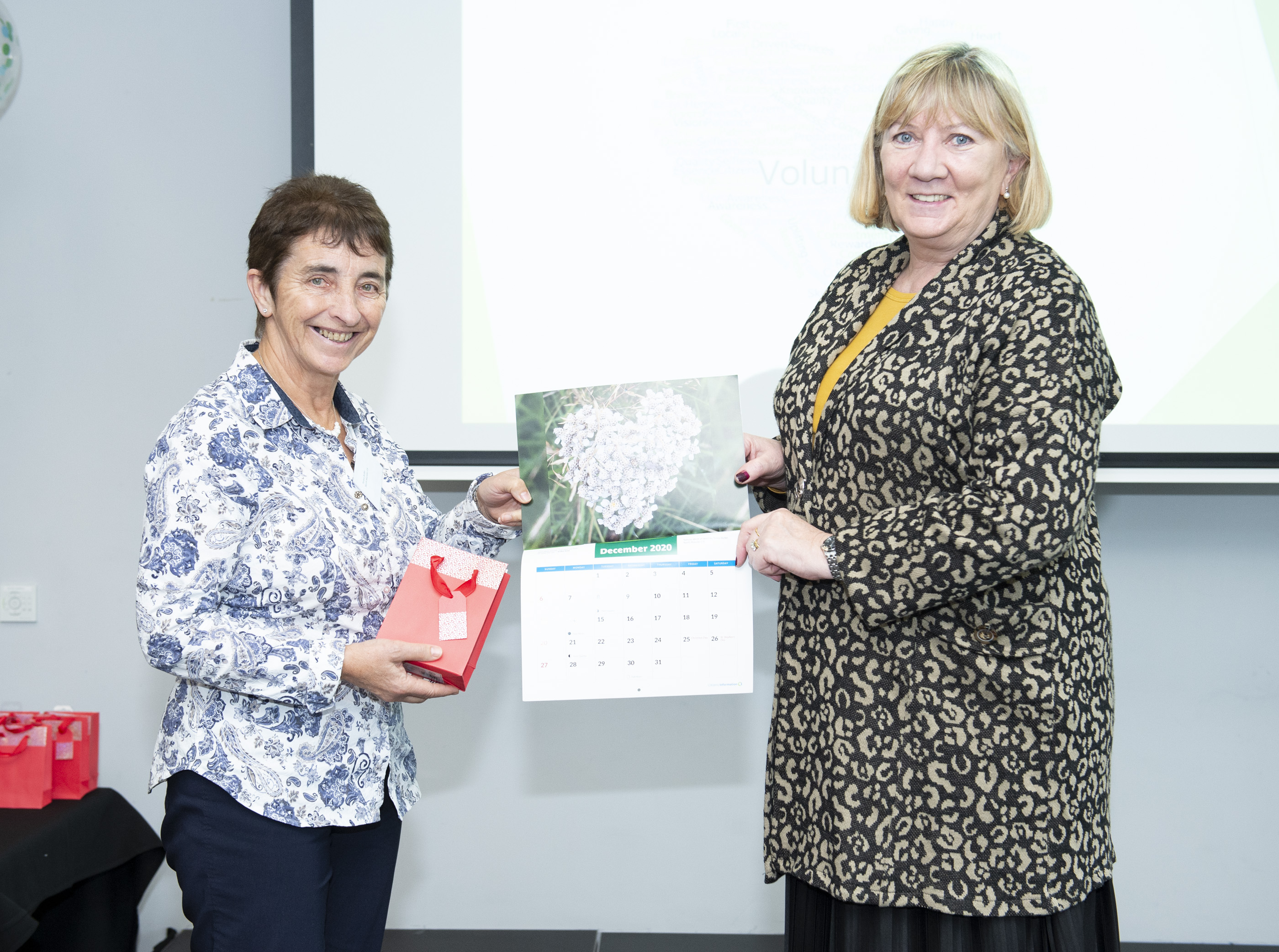 Angela Black, Chief Executive presents Teresa Butler, volunteer with North Munster CIS with her Calendar 2020 prize.